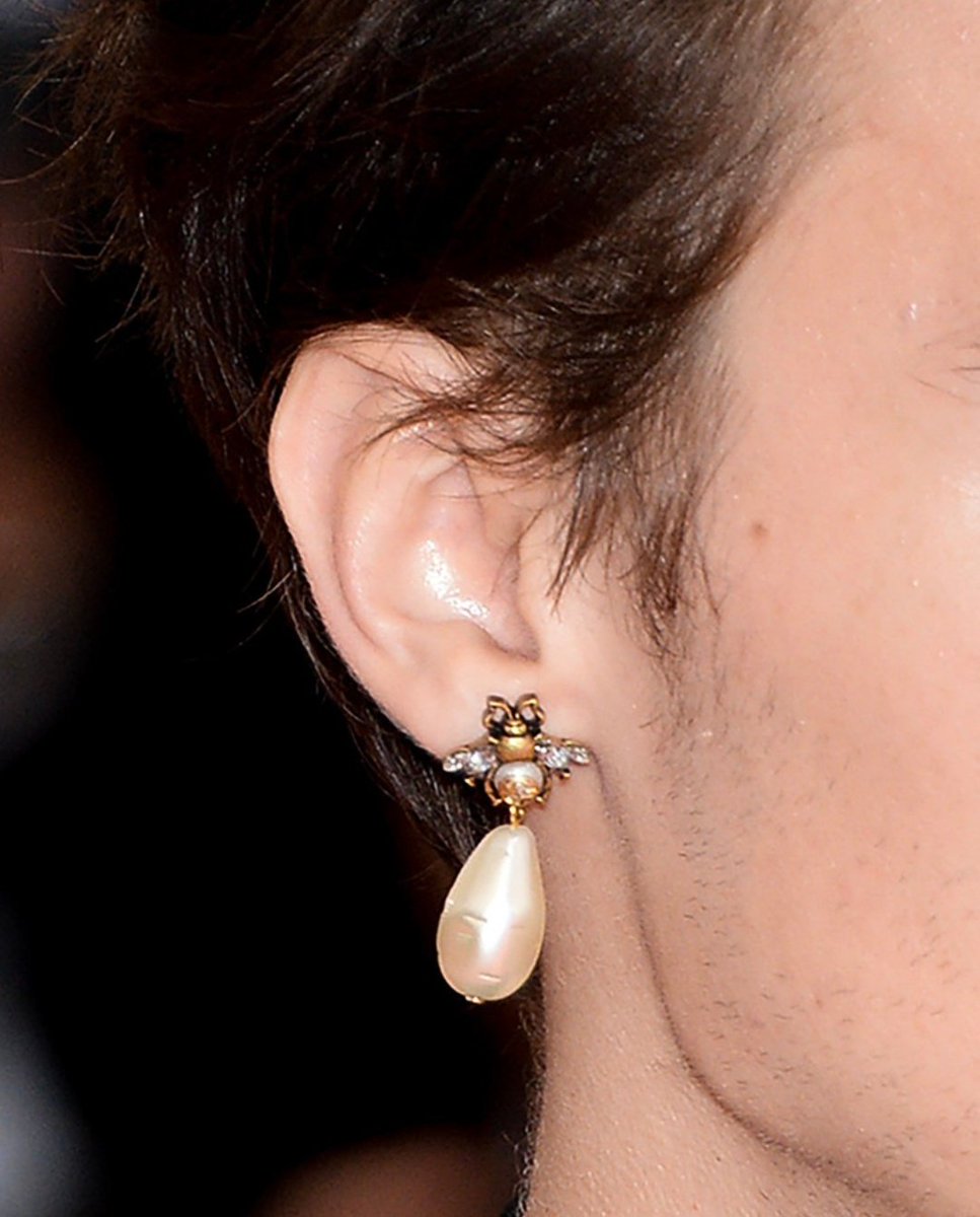 piercing his own ear before the met gala