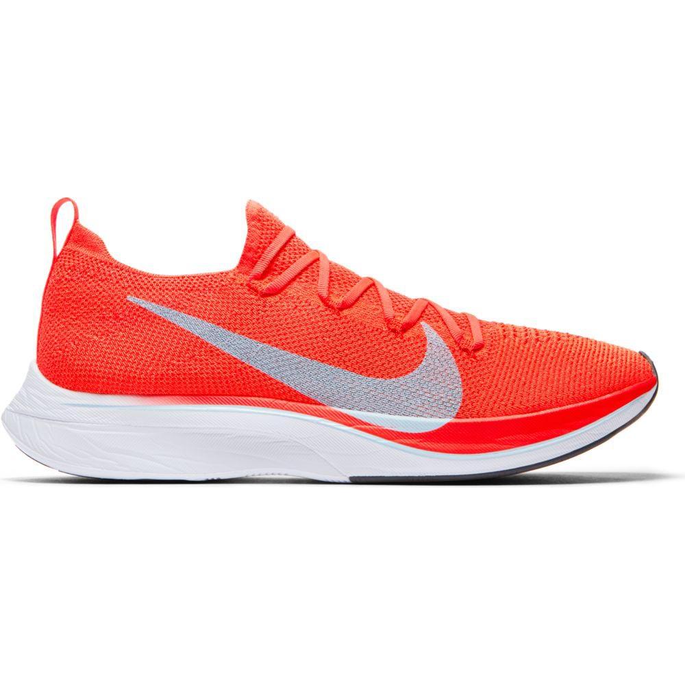 Kipchoge wore the Nike Zoom Vaporfly 4% flyknit, a 195 g 'super shoe' with Nike ZoomX foam (PEBA) and a curved carbon fibre plate. The 4% in the name comes from this study:  https://link.springer.com/content/pdf/10.1007/s40279-017-0811-2.pdf which compares the shoes to Kimetto's racing flats (4/13)