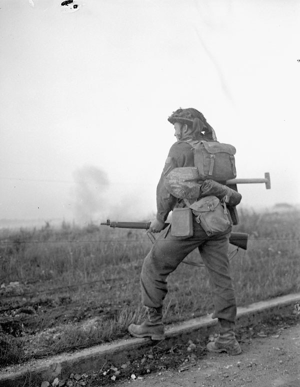 Private R. Pankaski waiting for the end of a medium artillery barrage before moving forward during Operation Spring near Ifs, France, 25 July 1944.

amzn.to/3tSqlTl