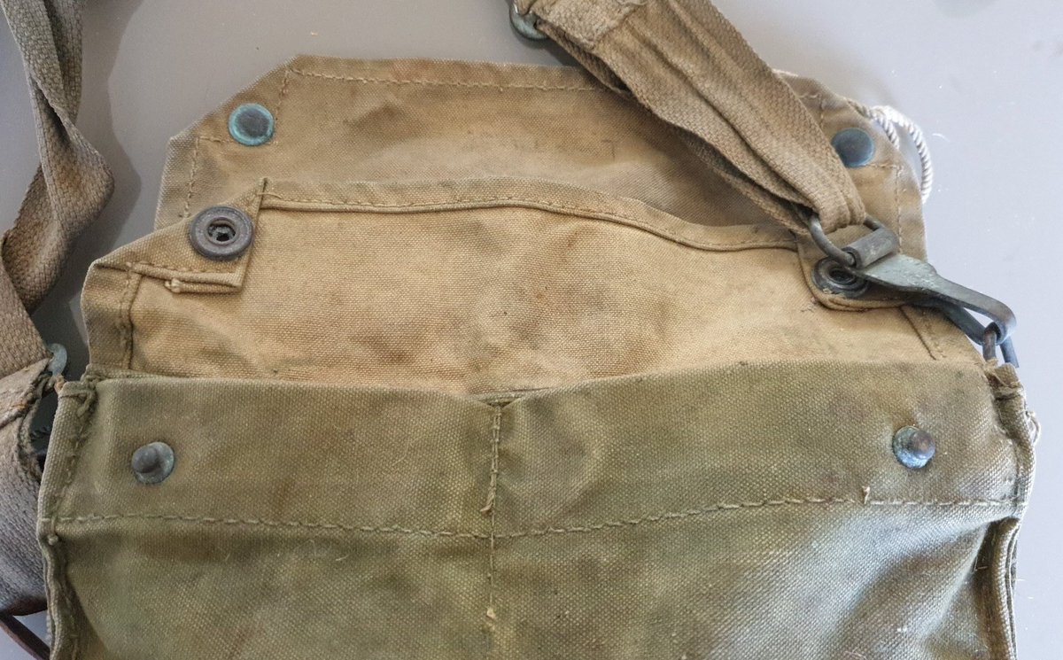 The haversack has two uneven pockets on the back. This together with the brass strap fixings lead me to believe this is a Mk VI gas mask haversack. The pockets were for anti-gas eyeshields and an anti-gas ointment tin... 2/