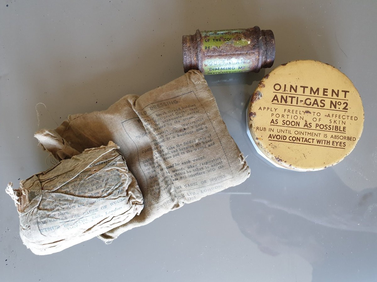 These are the remaining contents of the haversack: field dressings, anti-gas ointment no. 2 and anti-dimming paste Mk V. The ointment was for the treatment of mustard gas burns and the paste to prevent lenses fogging up. I'm not going to open either of those  7/