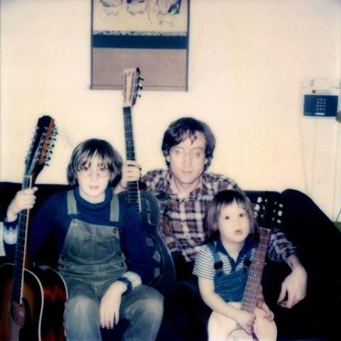 John Lennon sitting with his sons Julian and Sean Lennon, 1977.
