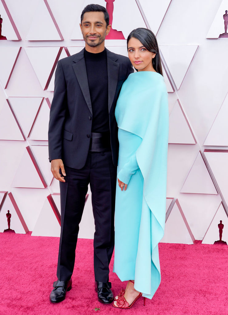 Riz Ahmed in satin cummerbund is smartly taking backseat to the gorgeously simple mint-blue gown of Fatima Farheen Mirza, New York Times bestselling novelist, person with great taste in footwear, and Ahmed’s wife  #Oscars  