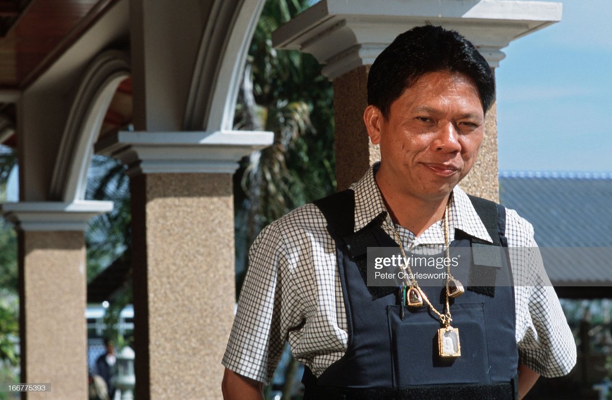 In 1999, Democrat MP Panawat Liangpongpan, from a rival Buriram gravel quarrying clan to the Chidchobs, was shot several times by a hitman who confessed he was hired by Newin's older brother. Panawat survived and began wearing a bulletproof vest and amulets for protection. 5/16