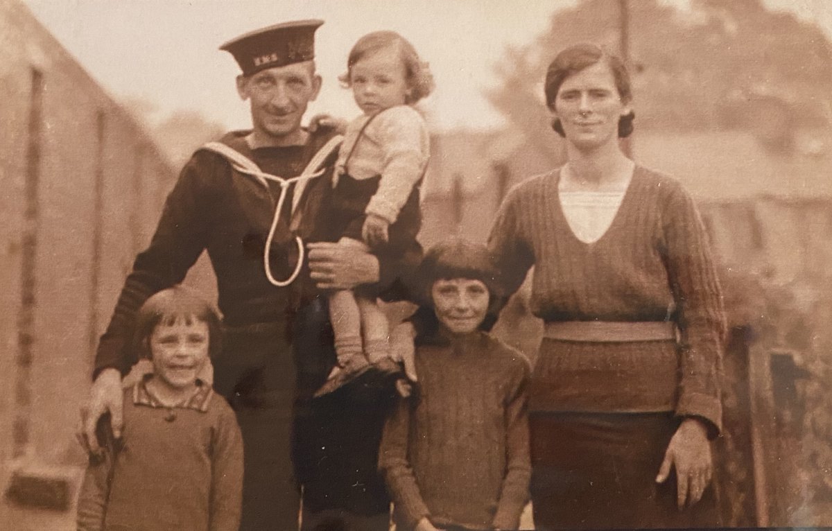Pictured below is Hugh in his father's arms along with his mother, May and sisters Sue and Marie.