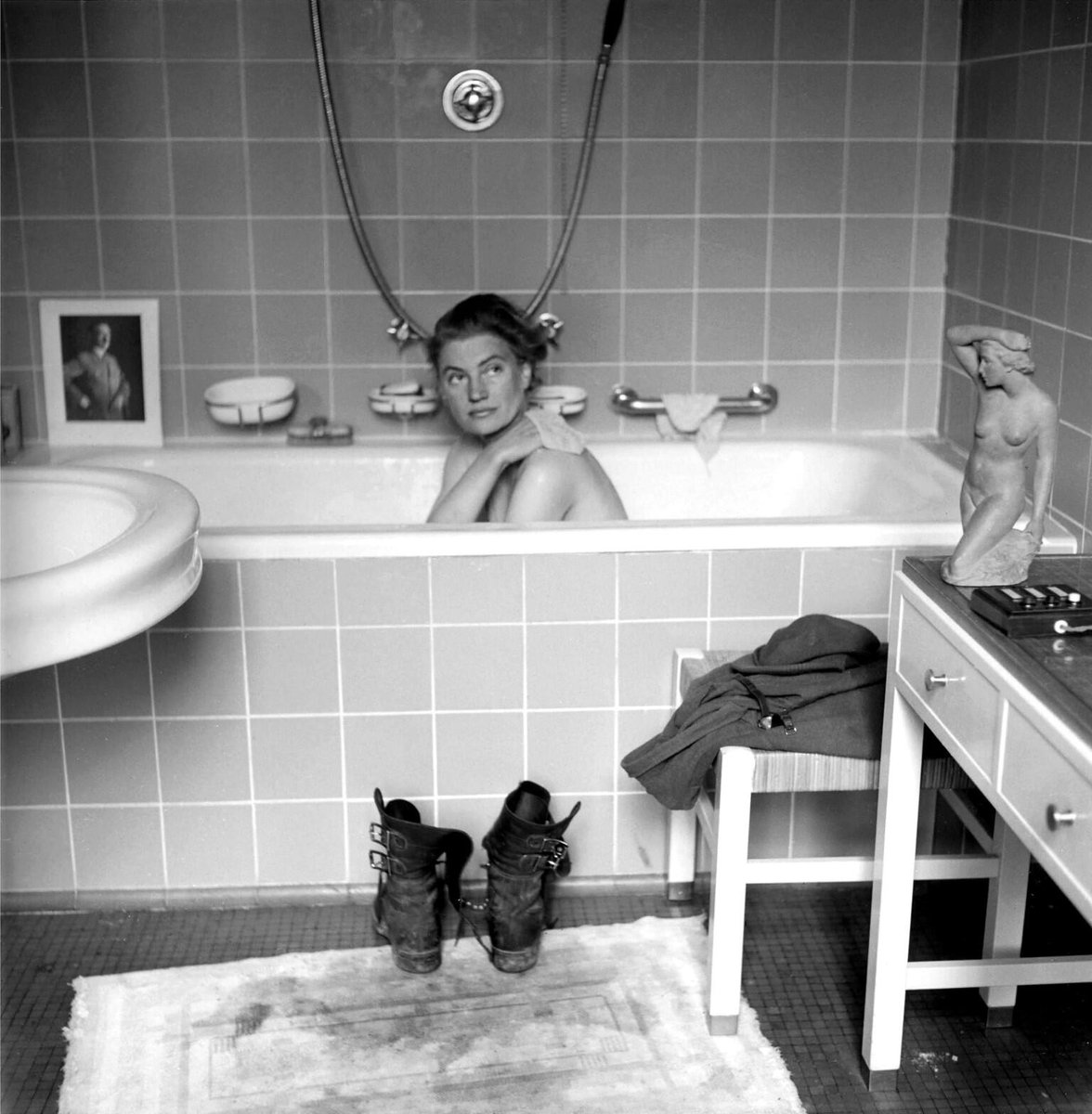 Photographer Lee Miller poses in Hitler's Munich bathtub as Allies are on verge of Victory in Europe, this month 1945:      #Getty
