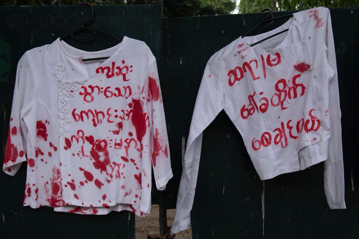 IrrawaddyNews's tweet photo. Rejecting the military regime’s plan to reopen #schools in May, students displayed uniforms stained with red paint in front of a government school in #Yangon’s San Chaung Township and vowed not go back to class until civilian rule resumes. 
(Photo: CJ)
#WhatsHappeningInMyanmar https://t.co/xmOe00q8lK