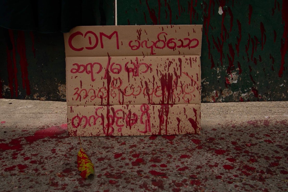 IrrawaddyNews's tweet photo. Rejecting the military regime’s plan to reopen #schools in May, students displayed uniforms stained with red paint in front of a government school in #Yangon’s San Chaung Township and vowed not go back to class until civilian rule resumes. 
(Photo: CJ)
#WhatsHappeningInMyanmar https://t.co/xmOe00q8lK