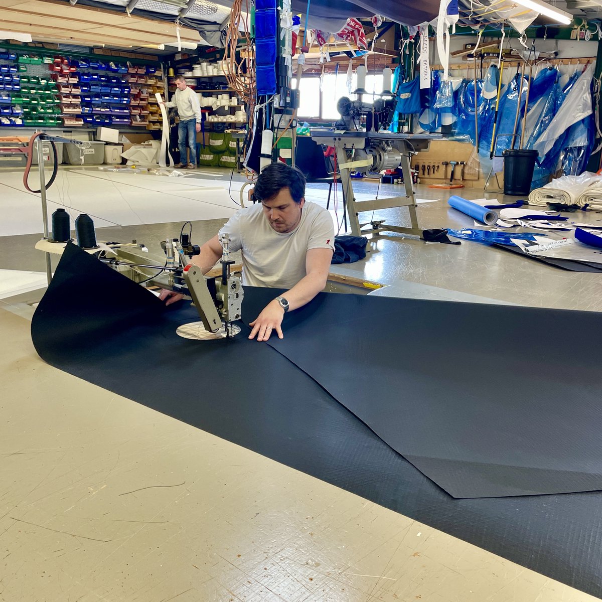 A look inside the loft... As ever, the team is busy hand making a range of sails and covers for boats of different shapes and sizes #onesails #sailmaking