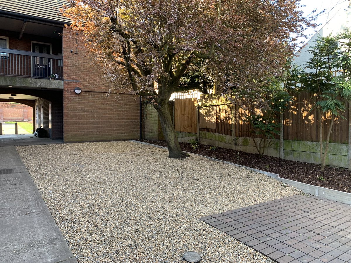MarkBcbh's tweet photo. The landscaping works at Attlee Gardens were completed earlier this week. Lee &amp; Carl from @idverdeUK did a great job planting the borders and replacing the gravel. Using the roots of the cherry tree to retain the border was a great idea! @ColBoroughHomes @EmmaLSchofield https://t.co/ggTFIohHBQ