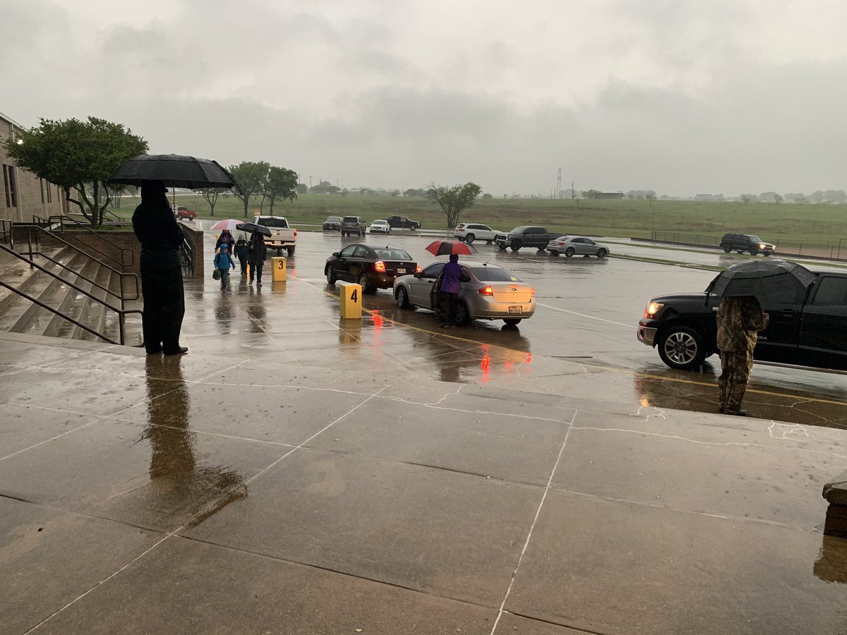 AEN car duty in the rain. The students are even getting an umbrella escort in as well..