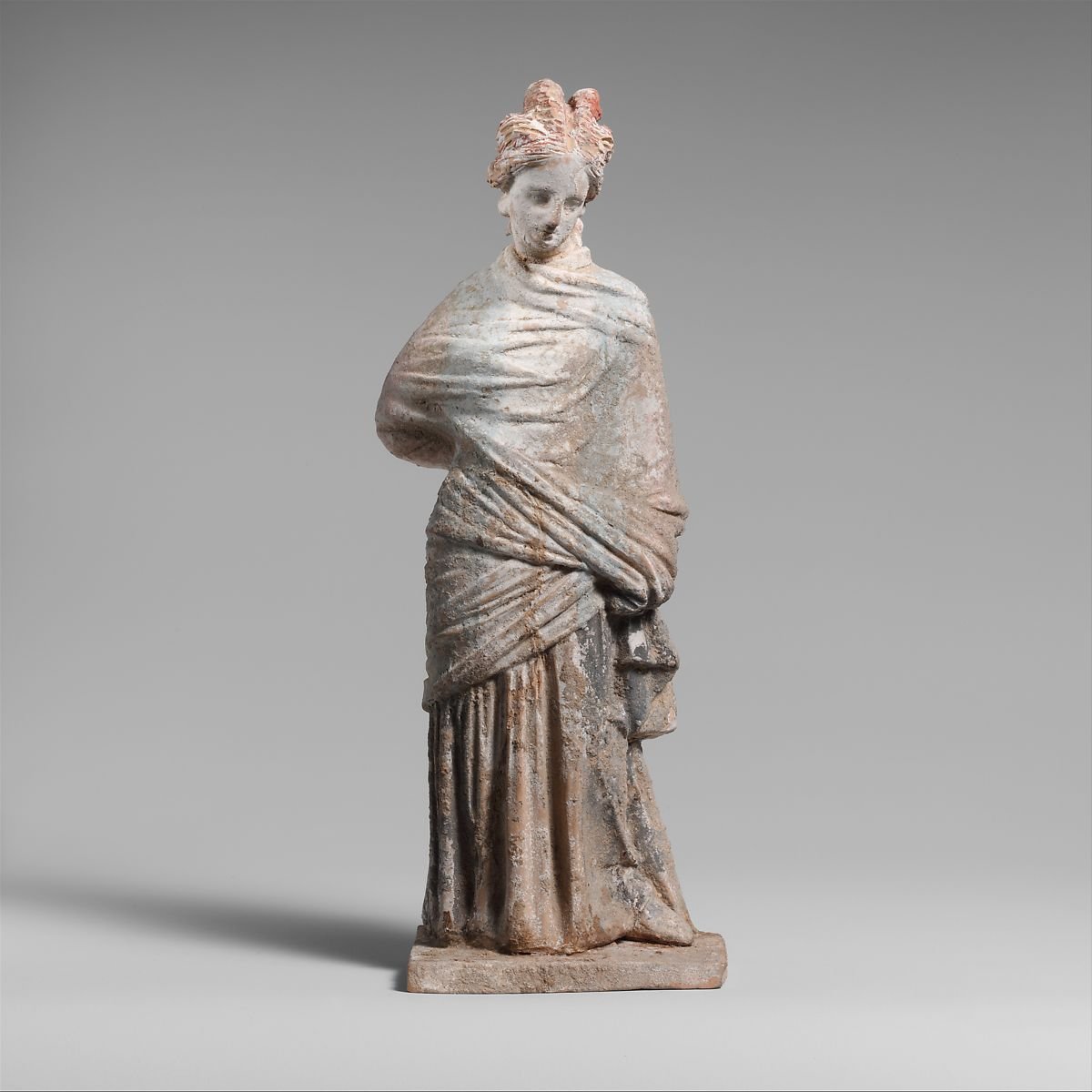 3/nTitle: Terracotta draped womanPeriod: HellenisticDate: 3rd century B.C.Culture: Greek, BoeotianMedium: Terracottaimensions: H. 7 3/4in. (19.6 cm)Accession Number: 07.286.2 #Archaeology