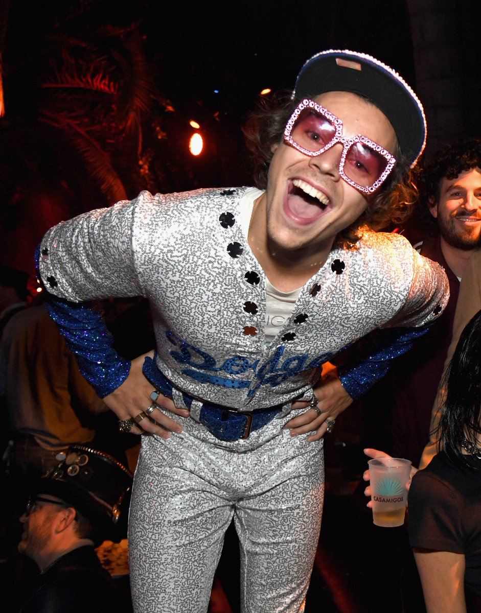 Iatenightdrivin's tweet photo. harry's halloween costume was a spot-on imitation of Elton John’s iconic sparkle-covered Dodgers uniform, which he wore in 1975. harry had the costume designed specially for him. we love a man who takes his halloween costumes seriously https://t.co/ORejxodyeI