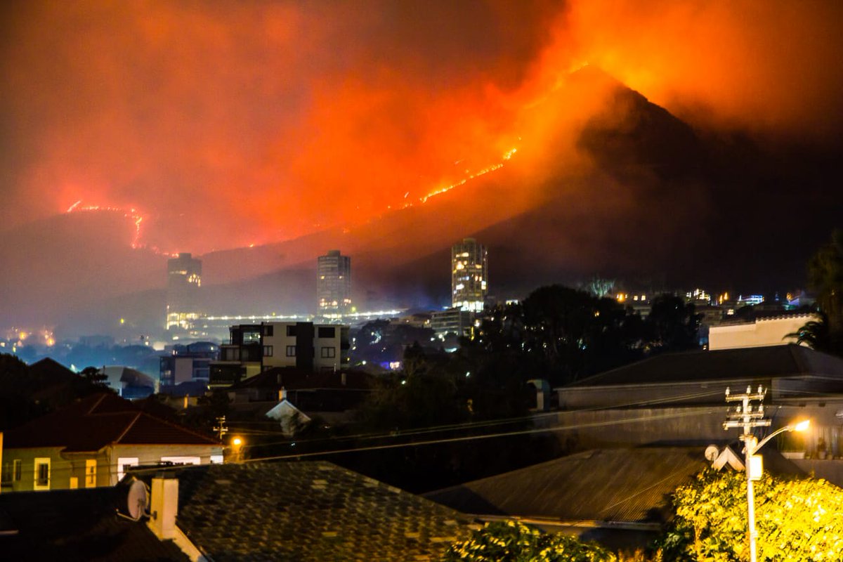 The fire on the slopes of Table Mountain which gutted the Jagger Library, fanned by strong winds that started up again at 2am this morning, is still raging out of control. This photograph, taken at 5am today, shows the flames now encroaching on the high-lying suburb of Vredehoek.