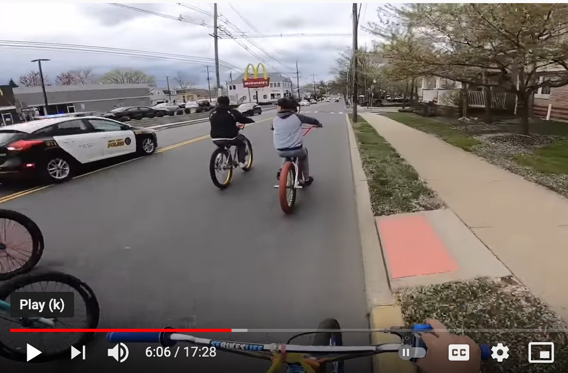 Kids rolling 30-40 deep on their bikes in Perth Amboy, NJ got chased at high speeds by several police cars til a few of them got cornered on a quiet street. One older gives them a talking to and tells them to be safe. And it seems like they'll be let go. They even clap for him.