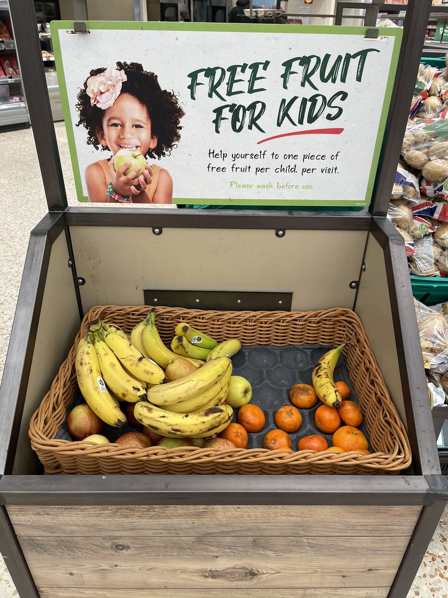 Baumski's tweet image. In #morrisons and this is what passes for corporate social conscience. Picture shows kid enjoying a lush apple when the reality is manky-looking fruit.  Parents should not be grateful for this crap fruit. Make this stop. Make it go viral. #shameful #exploitative #virtuesignaling