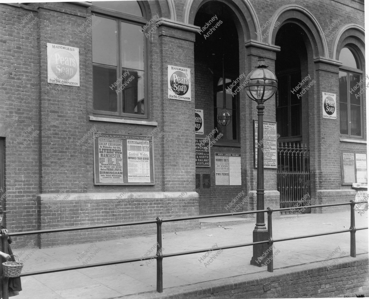 Homerton station entrance (detail). Adverts suggest photograph taken June 1898