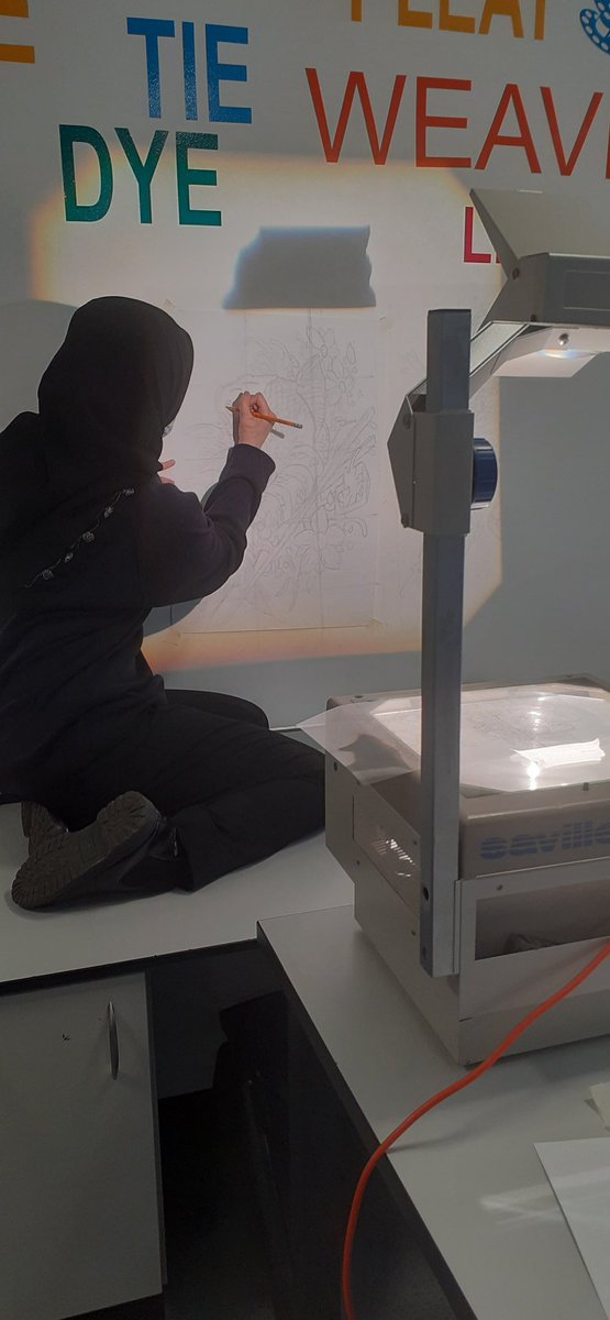 An increable DMA scholar working hard on her art project using some old school techniques