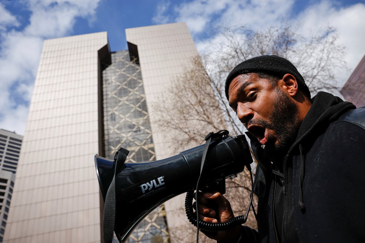 A protester shouts into a megaphone in front of the Hennepin County Government Center as a crowd awaits the verdict in Derek Chauvin's trial. Watch live:  https://bit.ly/3dBpzok    @ReutersBarria