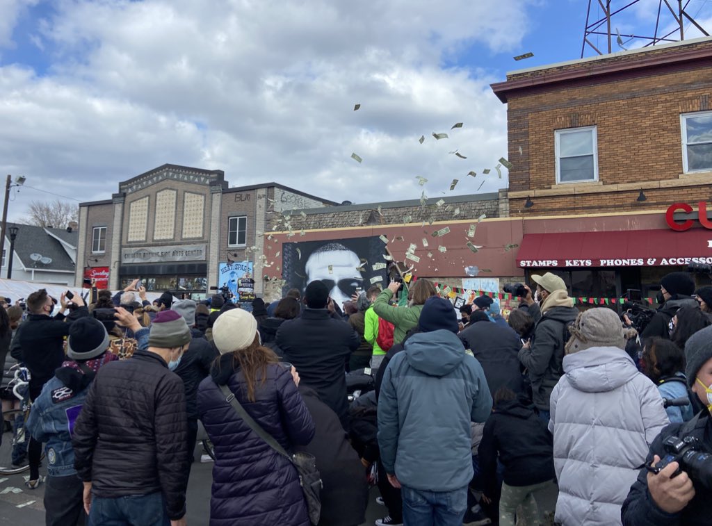 Activists started throwing money into the air and the crowd started cheering even louder