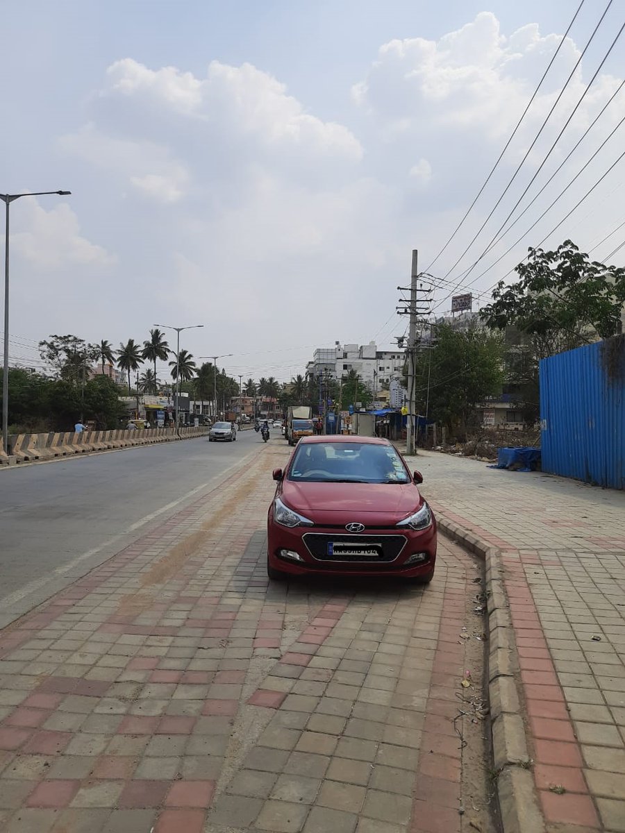 . @blrcitytraffic As you can clearly see in the photo, this is a parking area, away from the road and footpath. The officer refused to even accept there is not even a no-parking board. I demand the illegal fine refunded and the erring officer reprimanded.  @CPBlr