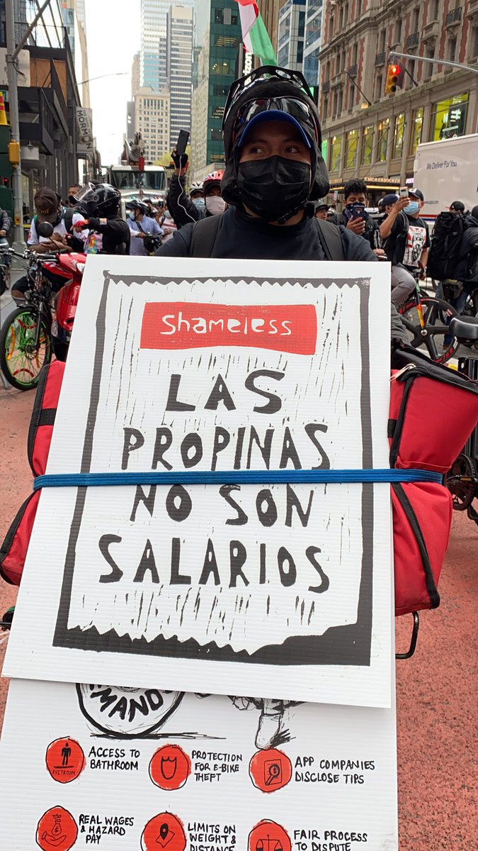 The workers redesigned the Seamless logo to read “Shameless.” The sign says: “tips are not wages.”