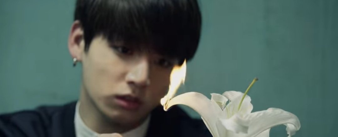 who lights the flowers with fire, right after which the lily behind yoongi starts burning. in "I need u" org ver. it was the reverse; yoongi tried to burn down the m0tel room & jungkook tried to save him. is it really the reverse? here, in yoonkook theory, the white lily is a ++