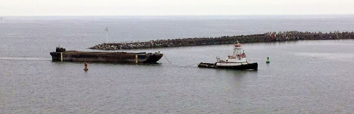 ...isn't evidence of absence.An ocean tug towing group in convoys to Okinawa usually had two tugs each pulling a pair of YOGL barges similar to the standard commercial barge in this photo with a small harbor tug.102/
