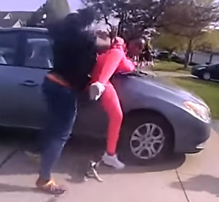 This is the exact moment the first shot was fired. The girl in pink is in more danger of being accidentally shot by the cop, than being stabbed by the 4 inch table knife. Once again, the cop could've tackled or tased this child.