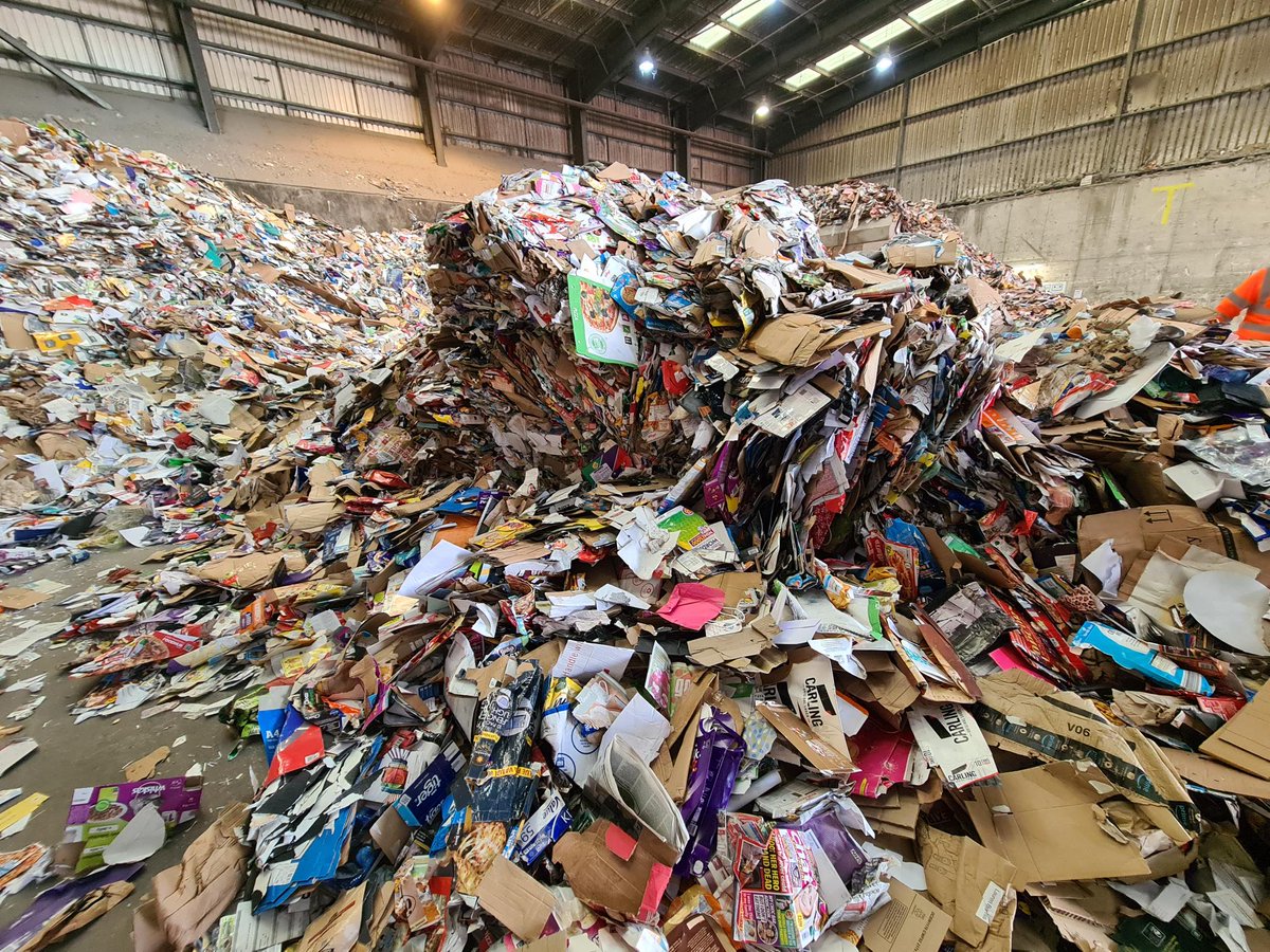 a big pile of paper and card at the tipping hall ready to be recycled