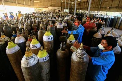 Workers refilling vital oxygen tanks