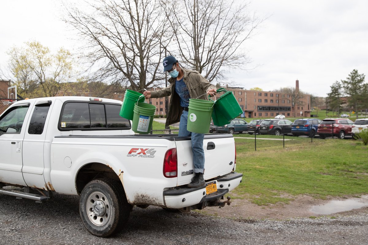 Yaro Bautista '23 collecting compost bins around campus.