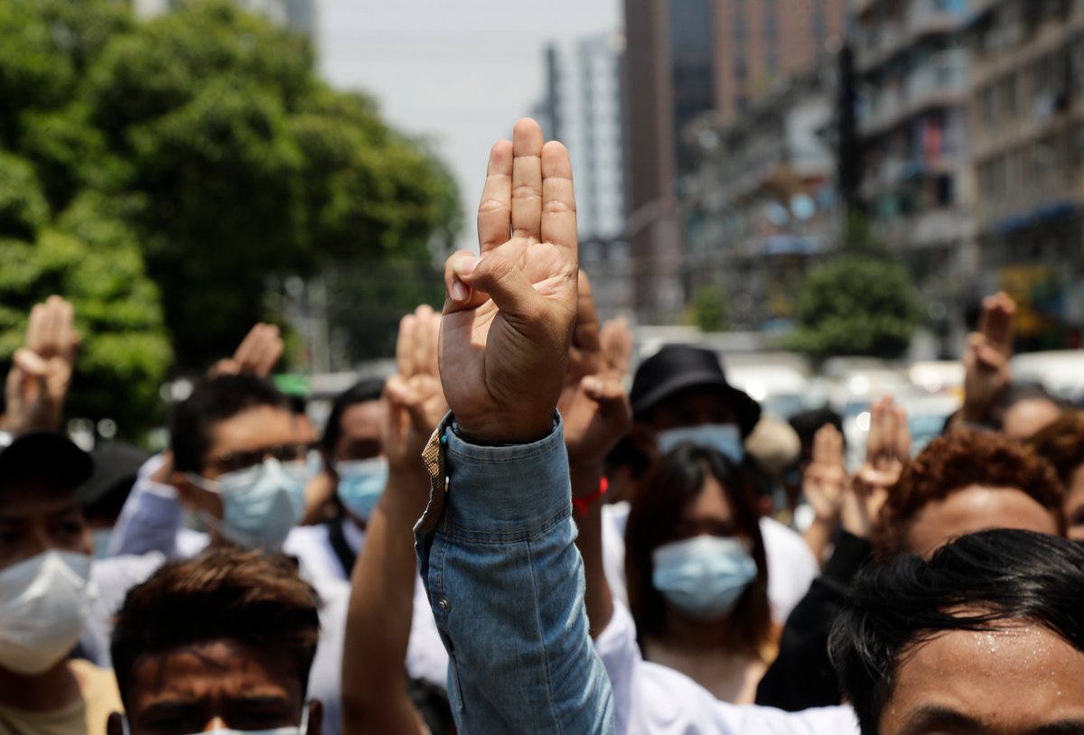 Protestors flash the three-finger salute as they march during a protest against the military coup in downtown Yangon today. According to the UN, nearly 3.5 million people in Myanmar may struggle to afford food in the coming months in the wake of the coup and financial crisis. EPA