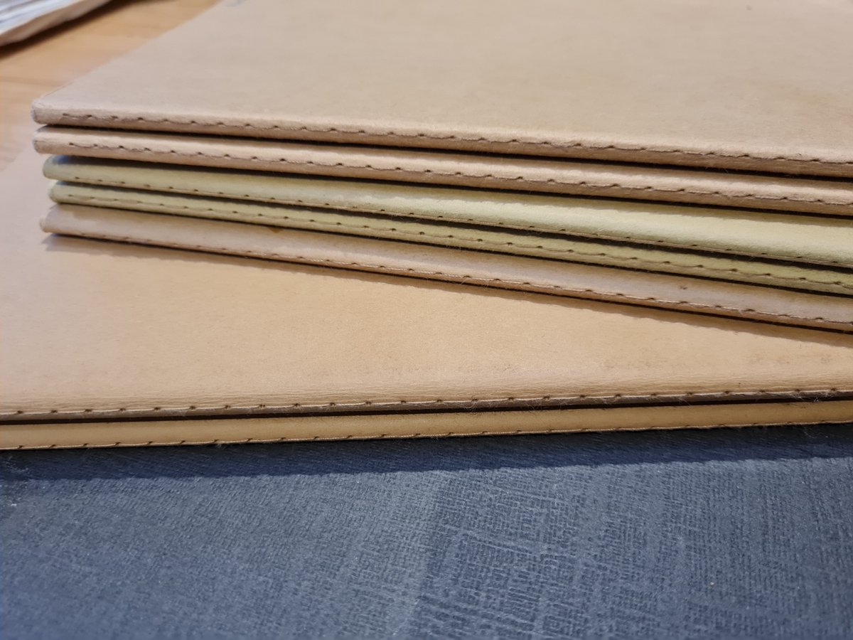 These are moleskines, and by far my favourite. I like that the binding is small, the soft cover, and the brown colour means it doesn't fade. There are also some pages with perforations so I can remove and share if needed without damaging the book. I use the unlined version