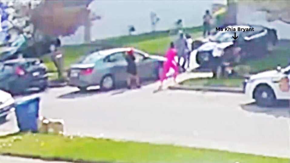 In this frame, Ma’Khia Bryant hovers over the girl on the floor, and Nicholas Reardon is pulling his firearm. The girl in pink moves towards Ma’Khia Bryant, and the man in the grey hoody moves towards the girl on the floor...