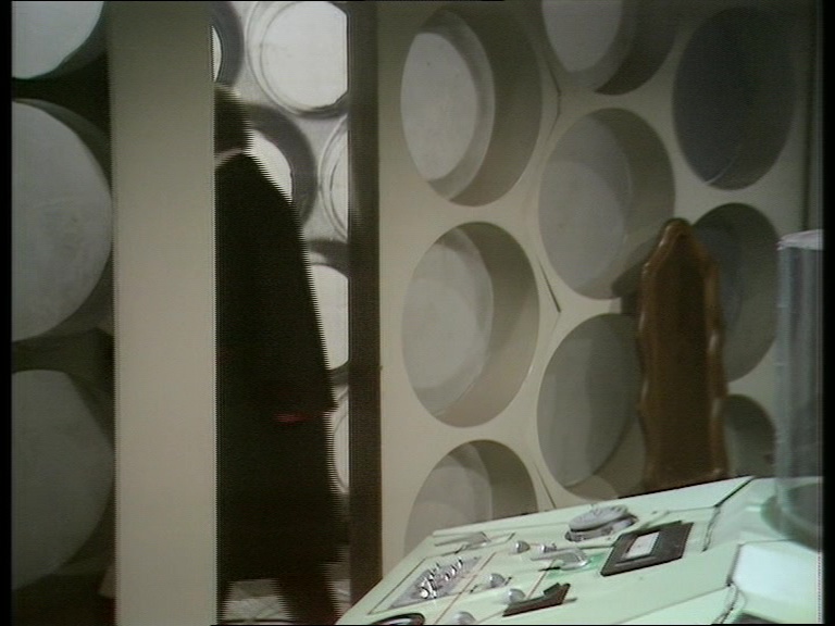 12/ Sharp oversaw the introduction of a new TARDIS console. The walls hadn't been seen since The War Games. The roundel left of the door had its Wheel in Space detail finally removed. The photo blow up walls were placed as a corridor outside the doors.