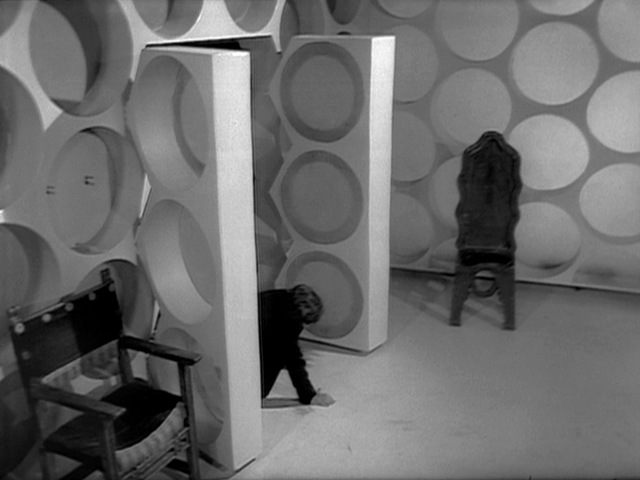 12/ Sharp oversaw the introduction of a new TARDIS console. The walls hadn't been seen since The War Games. The roundel left of the door had its Wheel in Space detail finally removed. The photo blow up walls were placed as a corridor outside the doors.