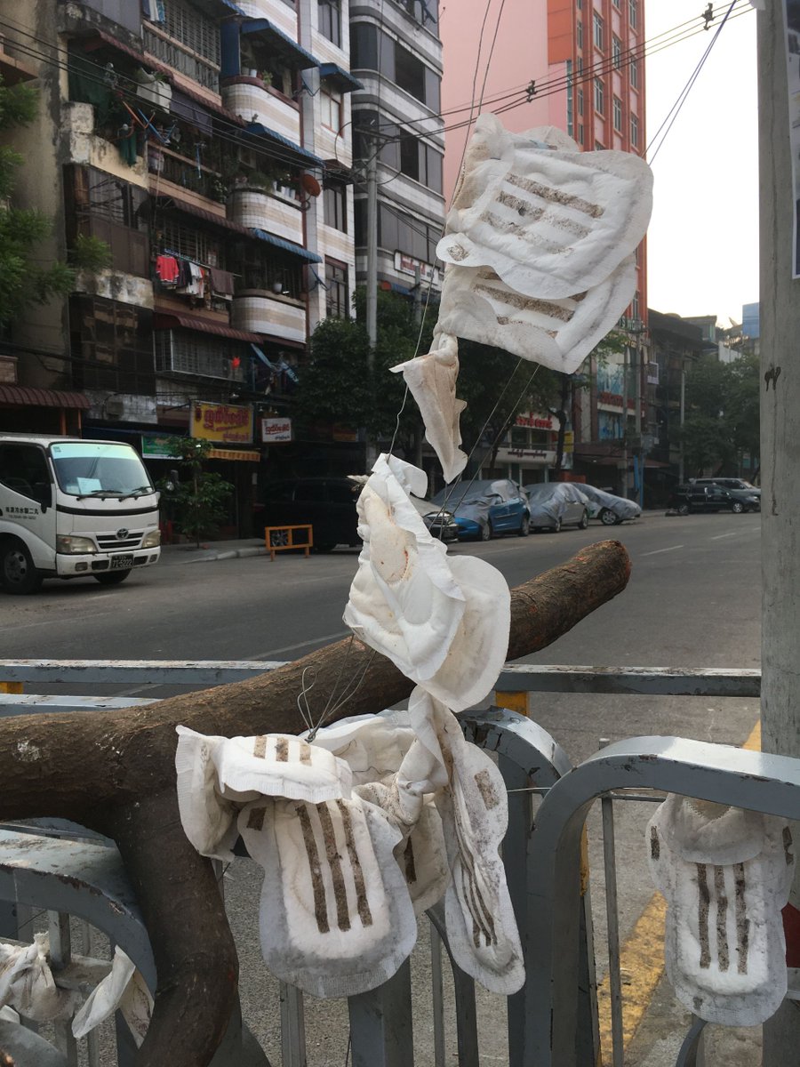 Burmese folk tradition holds that feminine items drain masculine power. Protesters have weaponized this irrational fear by draping their barricades with sanitary pads. 6/