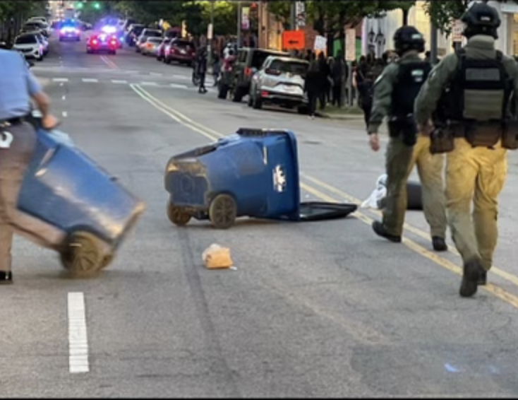 raleighpolice's tweet photo. The protest has been declared an unlawful assembly due to members of the crowd impeding the flow of traffic by tossing trash cans into the street. #RaleighProtest https://t.co/E4KduPPjIX