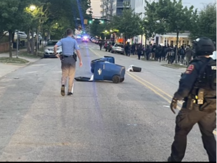 raleighpolice's tweet photo. The protest has been declared an unlawful assembly due to members of the crowd impeding the flow of traffic by tossing trash cans into the street. #RaleighProtest https://t.co/E4KduPPjIX