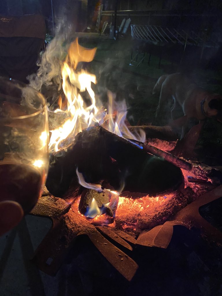 Cold weather is here in Australia, so it’s time for Red Wine, a fire bucket &amp; a ball mad Red Heeler! Cheers 🍷🔥🐕