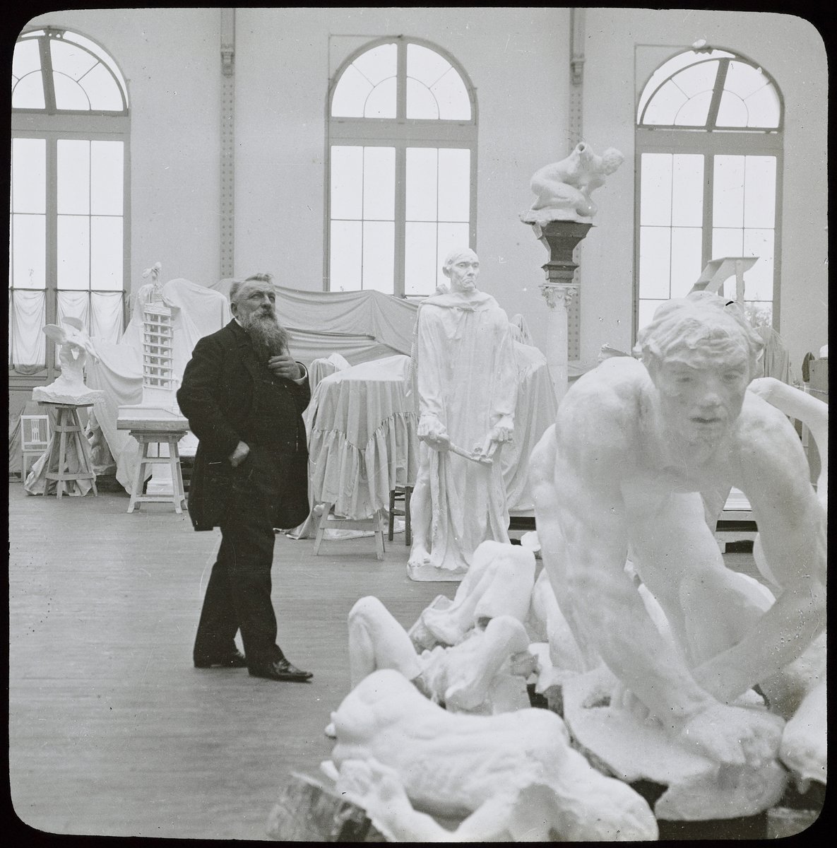 Auguste Rodin walking through his studio