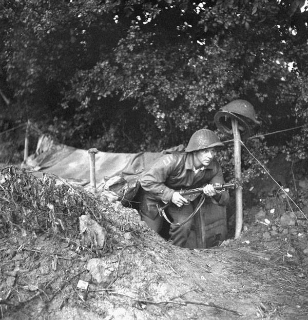 Sapper Joe Iaci, 6th Field Company, Royal Canadian Engineers (R.C.E.) coming out of his dugout, Normandy, France, 3 July 1944.

amzn.to/3dS8ExX