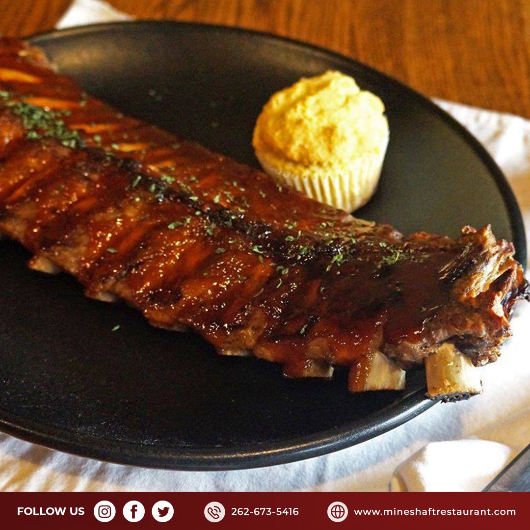 Tender pork ribs smothered with sweet, tangy sauce and served with beans and a cornbread muffin