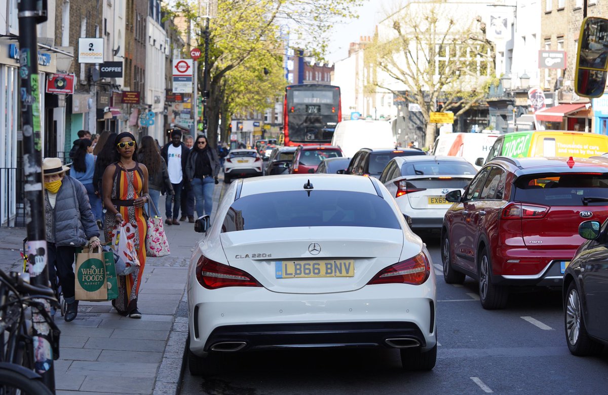 Camden Parkway. Watching the street for 2 mins today was a great reminder why we need a mayor in London willing to accelerate the journey to a fairer, more just, streets.Focus on the parked  @MercedesBenz for one moment... and the SUV behind it. Thread 1/7