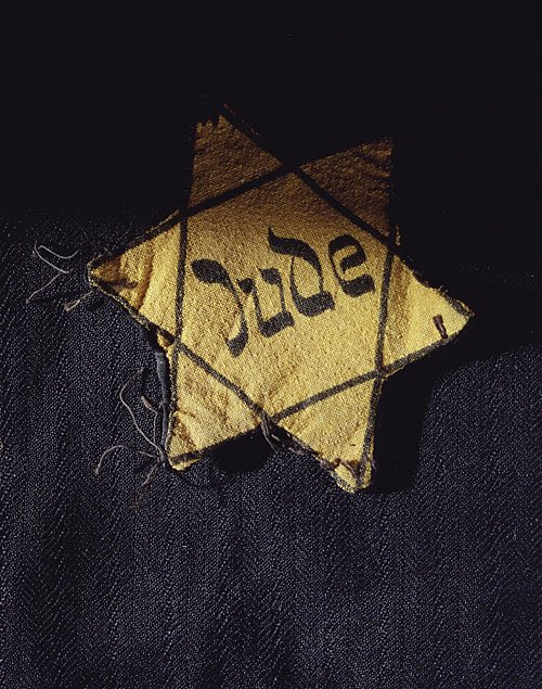 Starting with the symbol itself:The Star Of David is the modern symbol for Judaism and Jewish identity.The Nazis forced Jews and those who had Jewish relatives to wear these stars. They were forced to have it at a specific size. if it was too small, they would be prosecuted.