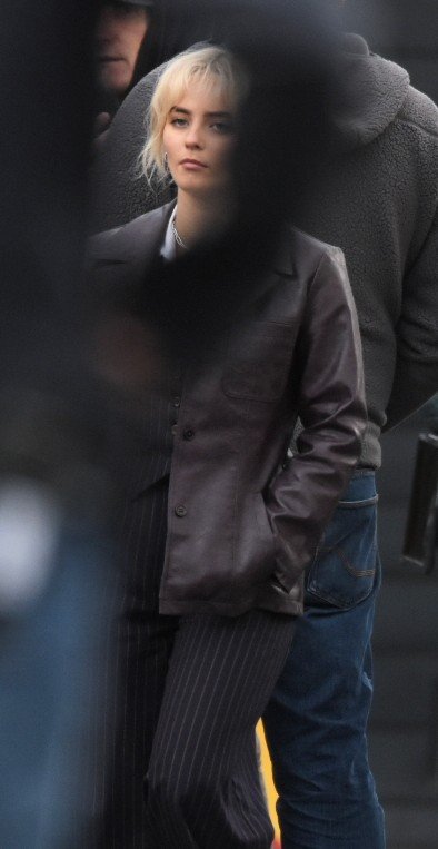 An obscured Millie Gibson on set, wearing pinstripe suit and jacket #dwsr