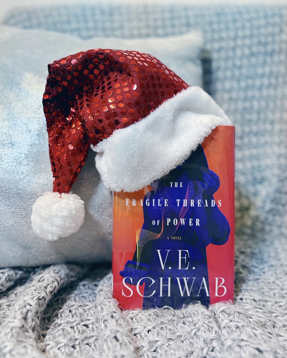 ClubGilmore's tweet photo. ❄️Holiday Bookstagram: Now and Then!❄️ By coincidence, I read some of V.E. Schwab's books during the holiday season, so I decided to recreate my original photos with the new book. 
❄️2023: The Fragile Threads of Power
❄️2021: A Conjuring of Light
@veschwab

First photo: A red boo https://t.co/EtbfstZstl
