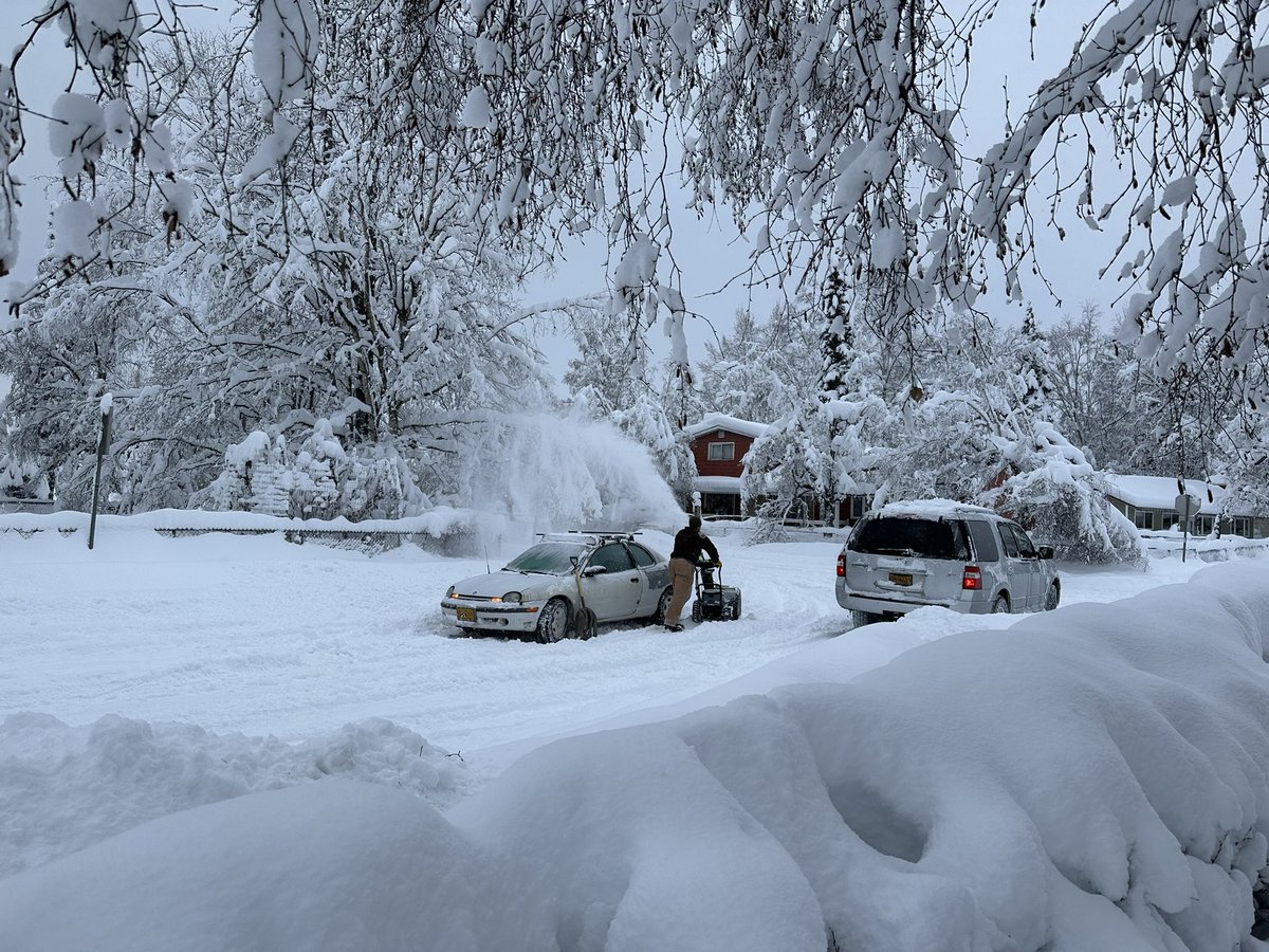 How things are at 11 a.m. on my street: A guy got stuck coming through the intersection. I helped him shovel out, but he needed more runway, so marched down the street to his house for his snowblower. Even that didn’t work so he’s now making a spot to park in by the curb. #akwx