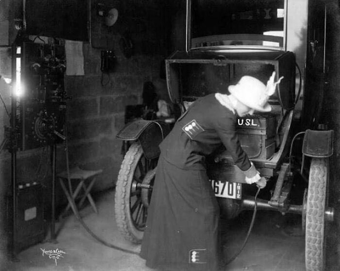 A lady charging her electric car, 1912